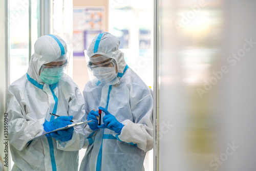 Asian doctor show corona or covid-19 blooding tube wearing ppe suit and face mask in hospital. Corona virus, Covid-19, virus outbreak, medical mask, hospital, quarantine or virus outbreak concept