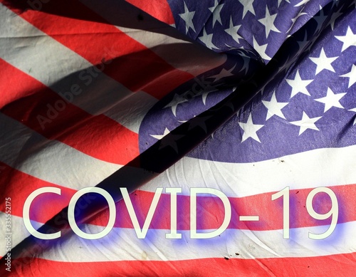 Fototapeta Naklejka Na Ścianę i Meble -  Flag of USA on wind with text COVID 19