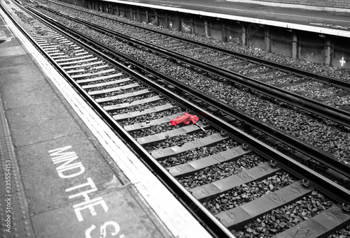 railroad tracks in the distance with red umbrella