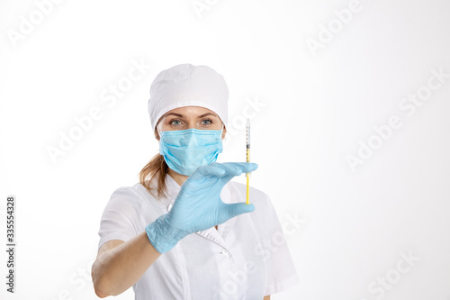 Doctor in a white coat holding a syringe.