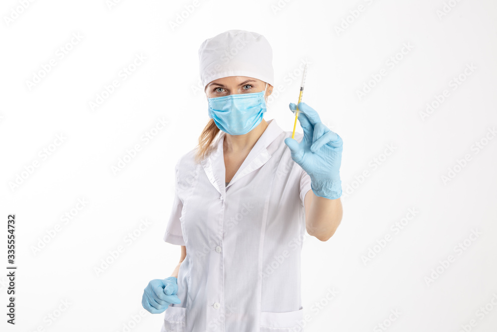 Fototapeta premium Doctor in a white coat holding a syringe.