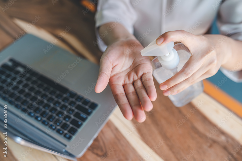 The woman's hand was washing her hands with an alcohol gel in a pump ...