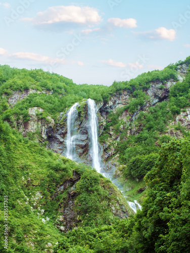 Double waterfall Polikarya in summer rocky mountains, Russia, Sochi.