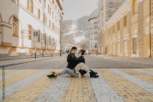 Man and woman kissing each other in protective medical mask on face on street. Environmental pollution concept. Guy, girl against pandemic coronavirus, virus protection