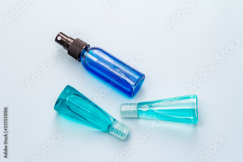 Sanitizer spray and gel isolated on blue background