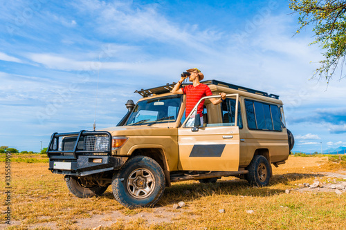 Photography Safari animal explorer looking for a wildlife from the heep front row