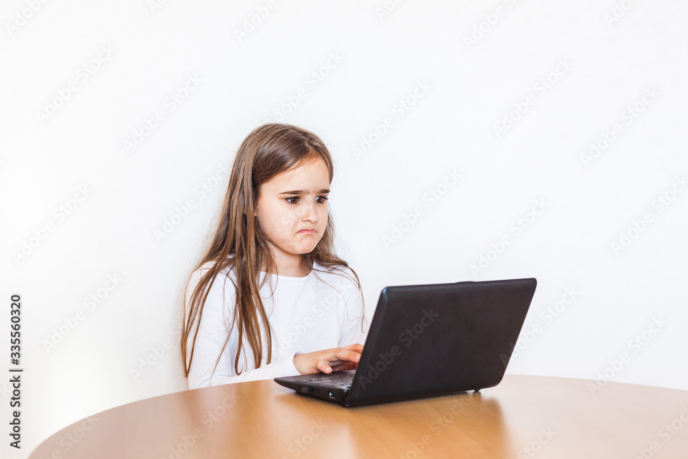 girl during the quarantine does homework using a laptop, tablet and the Internet, studying material, school, remote, learning from home, work, communication via the Internet, friends girl during the quarantine does homework using a laptop, tablet and the Internet, studying material, school, remote, learning from home, work, communication via the Internet, friends