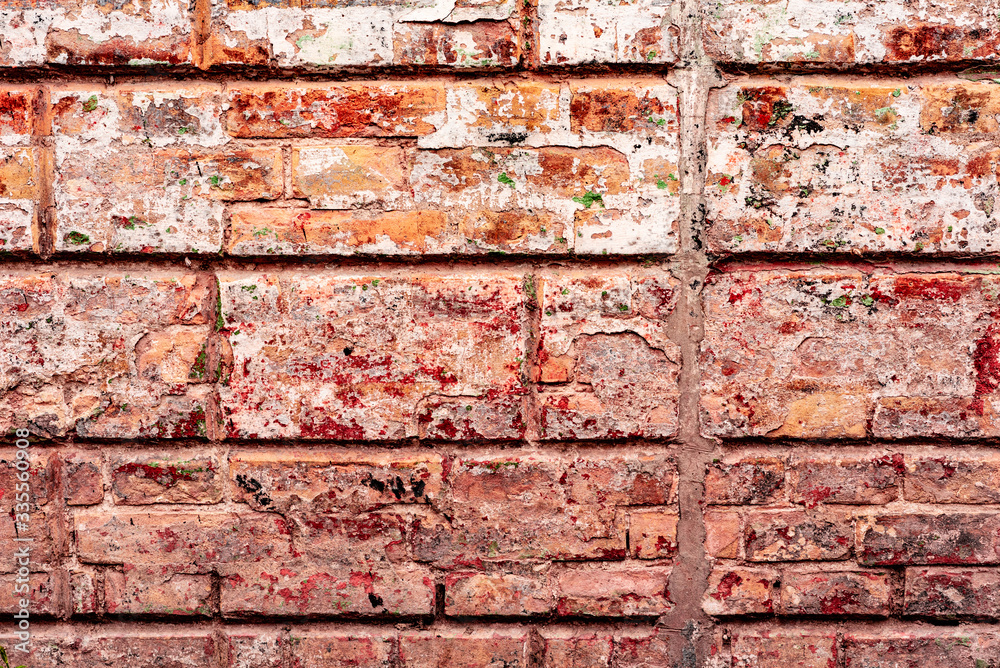 Texture of a brick wall with cracks and scratches which can be used as a background Texture of a brick wall with cracks and scratches which can be used as a background
