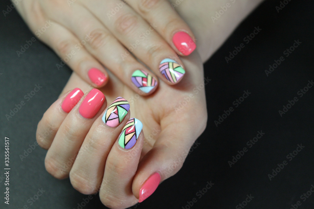 Fashionable manicure gel Polish on natural nails with abstract bright and geometric design on the hands of a modern girl Fashionable manicure gel Polish on natural nails with abstract bright and geometric design on the hands of a modern girl