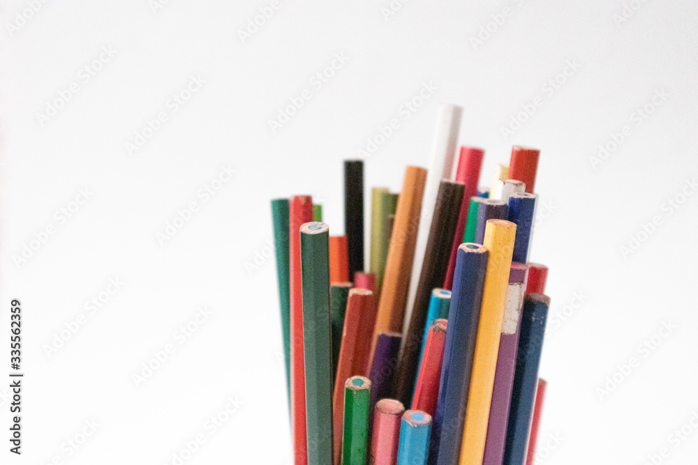 Colored pencils in a white background to make drawings and crafts at home during quarantine Colored pencils in a white background to make drawings and crafts at home during quarantine