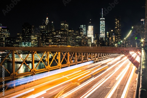 Light trails from the Brooklyn bridge overlooking financial district 