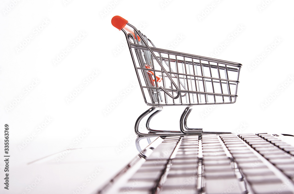 Online shopping concept with laptop computer and shopping cart Online shopping concept with laptop computer and shopping cart
