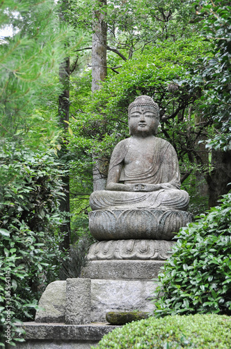 Sculpture of a Buddha statue in a zen garden. Kyoto  Japan.
