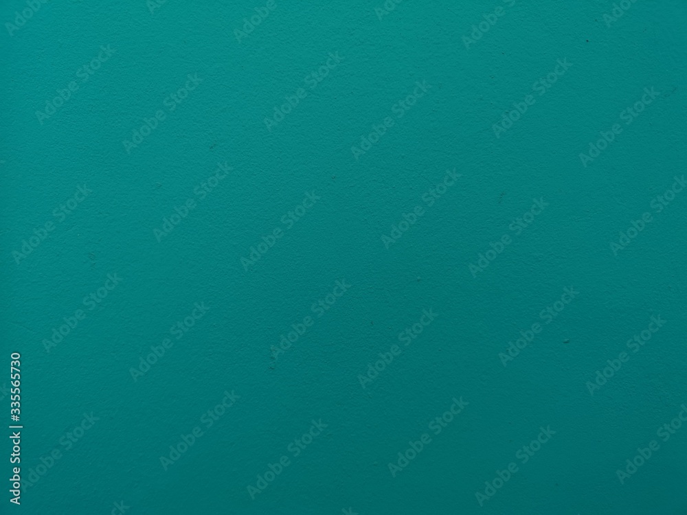 surface of the cement wall is rough, paint light curquoise color in texture material concrete background surface of the cement wall is rough, paint light curquoise color in texture material concrete background