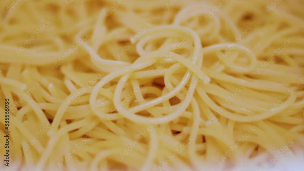 Cooked spaghetti in white colander Cooked spaghetti in white colander