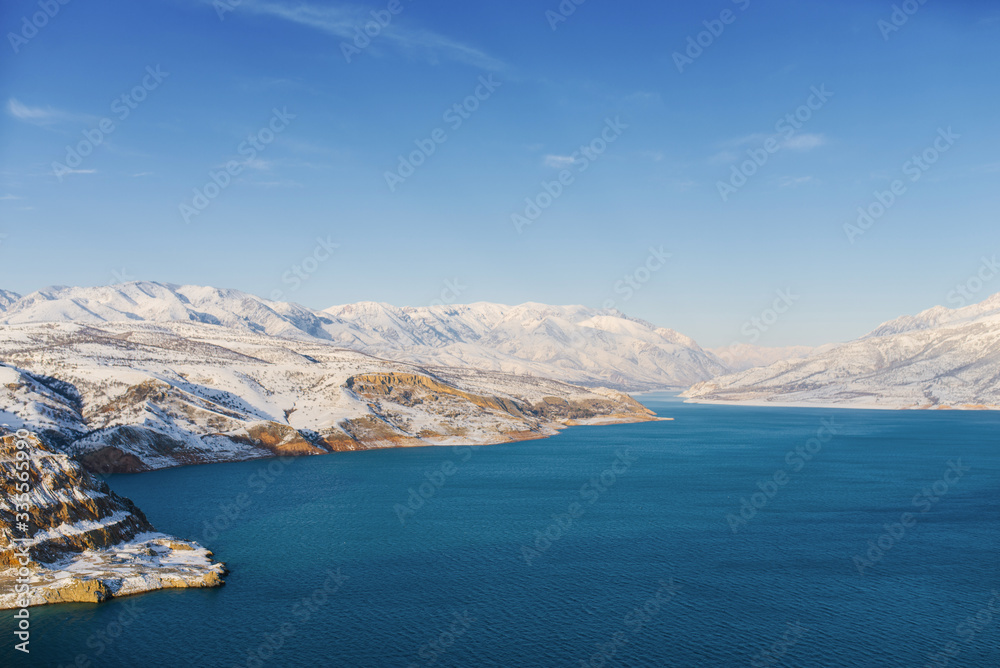 Amazing winter landscape of Charvak reservoir in Uzbekistan on a winter day