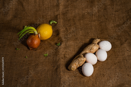 Vegetrian nutrition concept. Green onion with lemon and ginger with white eggs photo