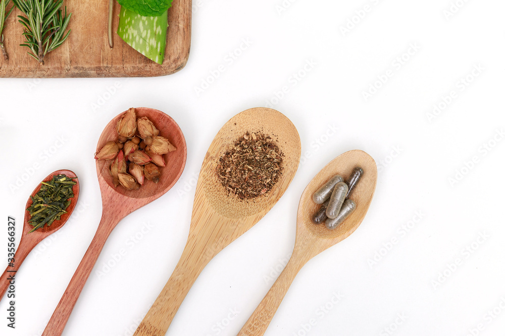 Top view of Herbal medicine preparation with fresh herbs and dried flowers, aromatherapy essential oil and mortar with pestle used in natural alternative remedies on white table. Top view of Herbal medicine preparation with fresh herbs and dried flowers, aromatherapy essential oil and mortar with pestle used in natural alternative remedies on white table.