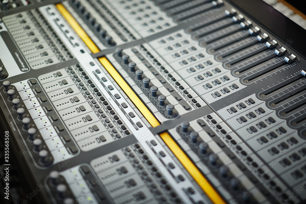 Fader buttons on a professional audio mixing console Fader buttons on a professional audio mixing console