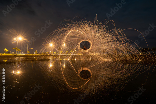 Burning of steel wool reflection in water.