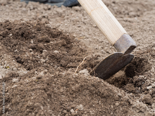 Wallpaper Mural Digging the soil with a hoe in spring garden Torontodigital.ca