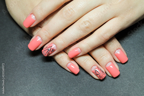 Fashionable gentle moon manicure gel Polish on natural nails with a geometric design on the hands of a well groomed woman