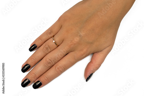 female hand with a ring on a white background