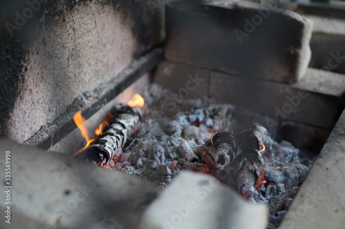 embers for barbecue in a grill of white brick