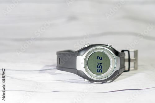 sports watch on a white wooden table