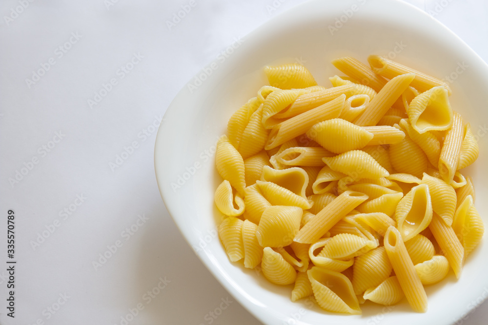 Spaghetti pasta in a white dish on a white background.copyspace for text