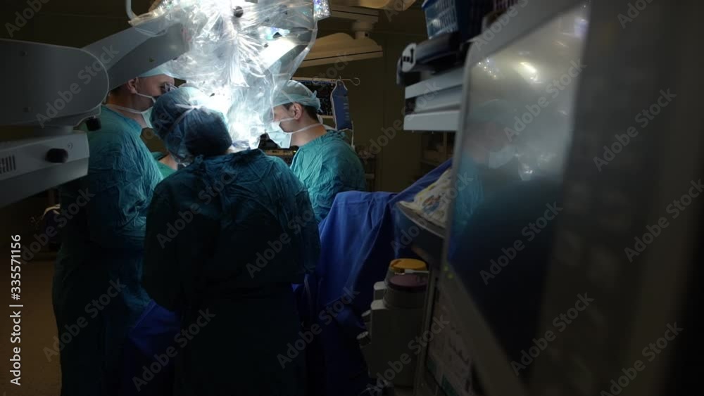 The team of doctors focuses on the patient during the operation in the hospital The team of doctors focuses on the patient during the operation in the hospital