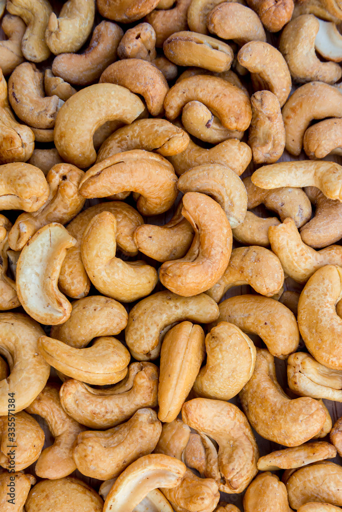 Tasty cashew nuts. The cashew tree is a tropical evergreen tree that produces the cashew seed and the cashew apple.