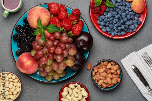 Tableau sur toile Seasonal fruits and nuts on concrete table, fresh ingredients for lunch