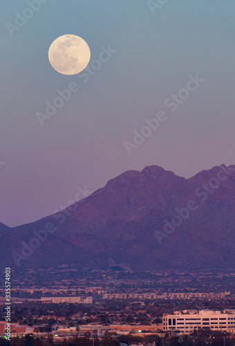  waiting for and then seeing a full moon rise from behind a colorful desert mountain with its thin brightness and perfection is a great past time. This Snow Moon rises in the Phoenix  Arizona area