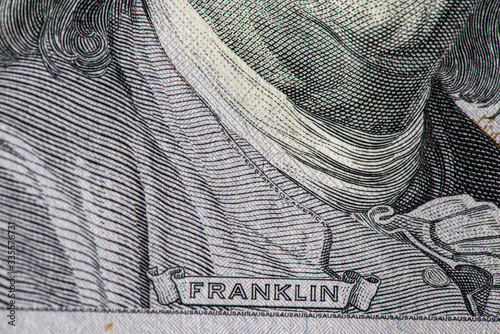 Fragment of a banknote of 100 dollars. Photographed close-up.