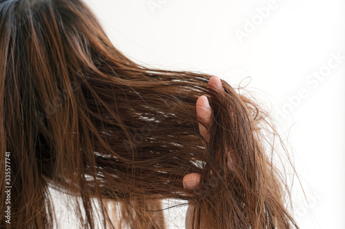 Woman brushing her wet messy hair after bath with comb, Thin hair porblem. Hair Damage, Health And Beauty Concept.