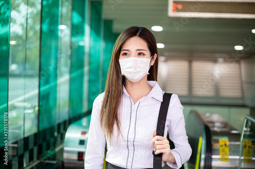 woman with mask in station