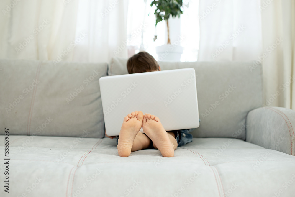 Fototapeta: Distance learning during isolation during quarantine in  coronovirus. Boy and laptop at home.... #335579737 | Naklejamy.com'