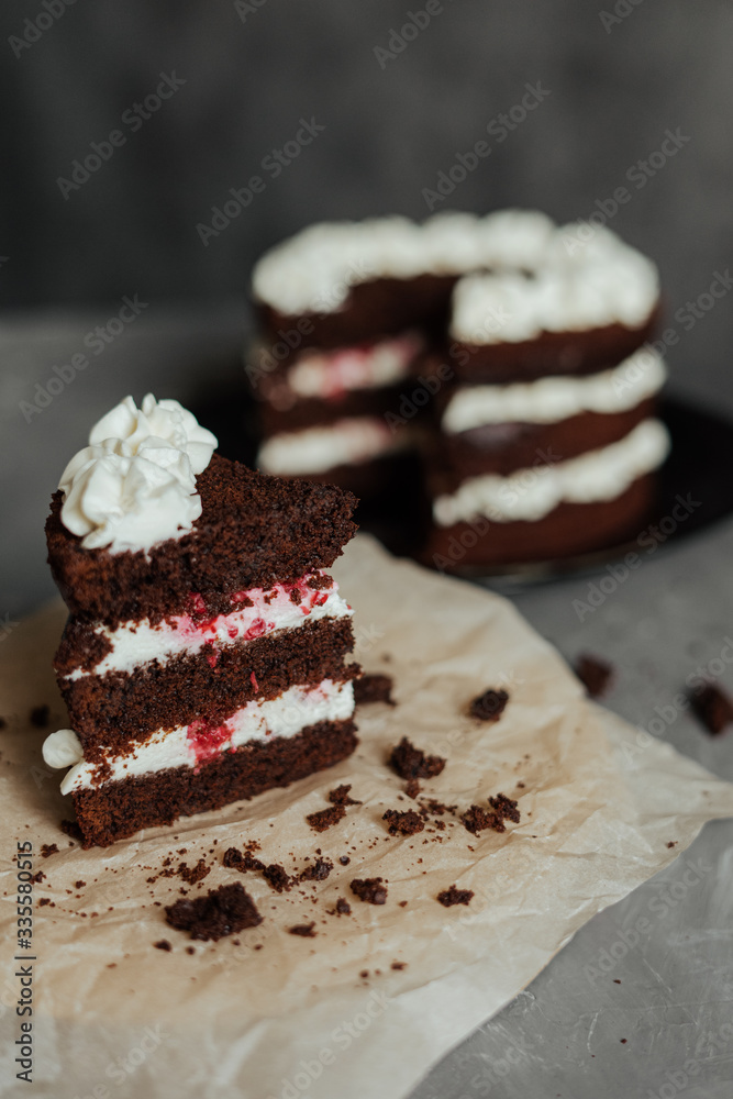 Chocolate cake with cream and raspberries. Cut piece