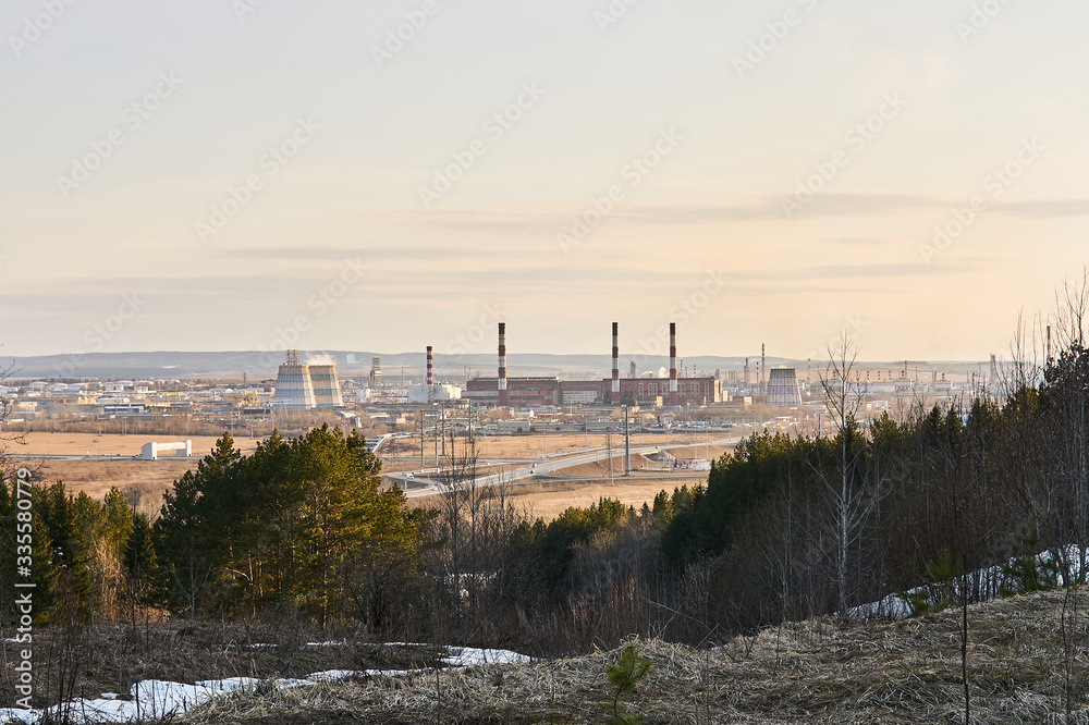 industrial landscape in early spring with a power station in the valley