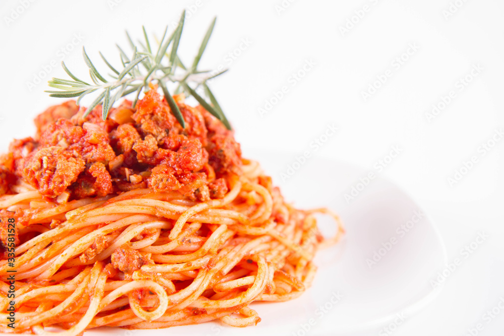 Spaghetti bolognese on a plate decorated with a rosemary twig Spaghetti bolognese on a plate decorated with a rosemary twig