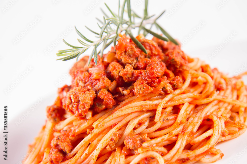 Spaghetti bolognese on a plate decorated with a rosemary twig Spaghetti bolognese on a plate decorated with a rosemary twig