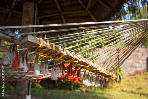 Wallpaper Mural A wicker suspended summer chair hangs in the shade of tropical trees. Close-up weaving Torontodigital.ca