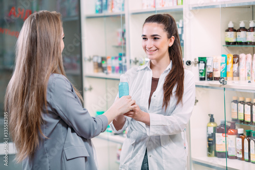 A beautiful pregnant woman consults at a pharmacy.