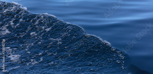 beautiful separation of water into a smooth surface and a storm. Blue Art. Water Banner. Liquid Ice. Icy Pattern. Ocean Texture. Abstract magical blue water. Water Waves Surface as Background