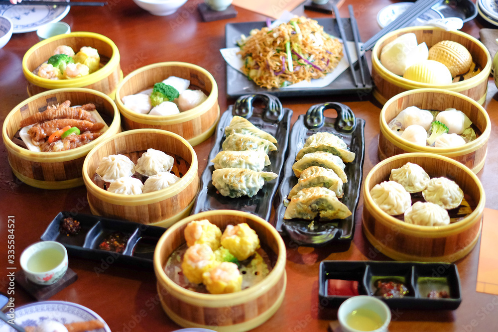 Mixed chinese steamed dumpling (dim sum), crab stick, ha gow, seaweed, coriander, noodle, gyoza and garlic for background or texture - food chinese concept. Mixed chinese steamed dumpling (dim sum), crab stick, ha gow, seaweed, coriander, noodle, gyoza and garlic for background or texture - food chinese concept.