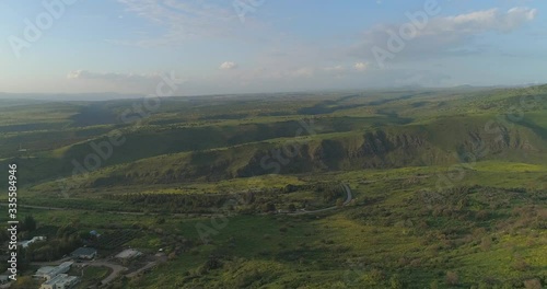 Aerial shot above Golan Heights and Taiberia in North of Israel. Open fields with green landscapes and mountains above Galilee sea or Kinnert at Jordan valley  photo