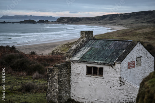 Watch house overlooking Whitepark bay, Causeway Coast, Antrim, Northern Ireland photo