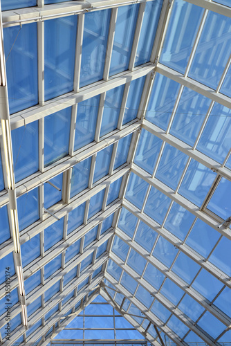 Modern glass roof and blue sky.