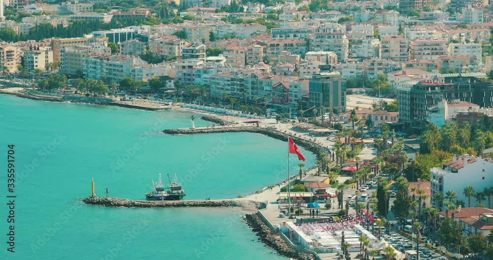Kusadasi, Aydin, Aydın Province, Turkey. Waterfront And Kusadasi Cityscape In Sunny Summer Evening. Scenic View Of Kusadasi Skyline At Aegean Coast, Turkey Kusadasi, Aydin, Aydın Province, Turkey. Waterfront And Kusadasi Cityscape In Sunny Summer Evening. Scenic View Of Kusadasi Skyline At Aegean Coast, Turkey